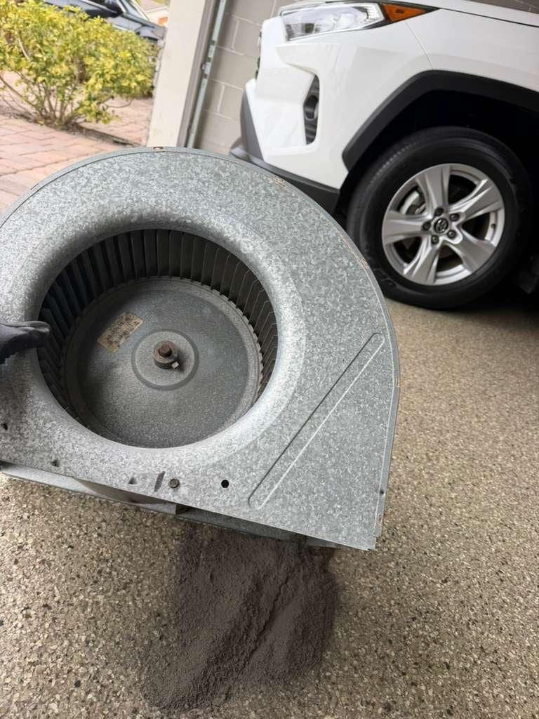 A cleaned blower wheel assembly, removed from its housing and set down for a final inspection