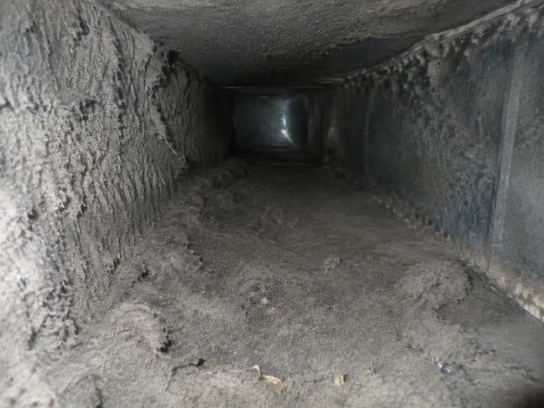 Flexible duct interior, coated in dust and debris.