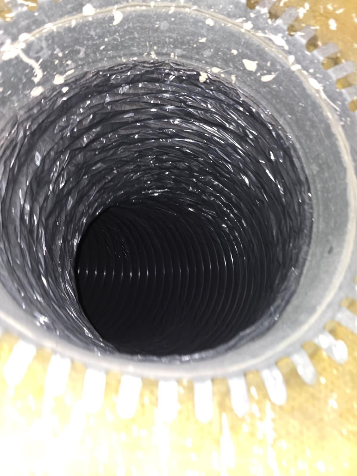 Duct boot with sunburst tabs leading to a black flexible duct